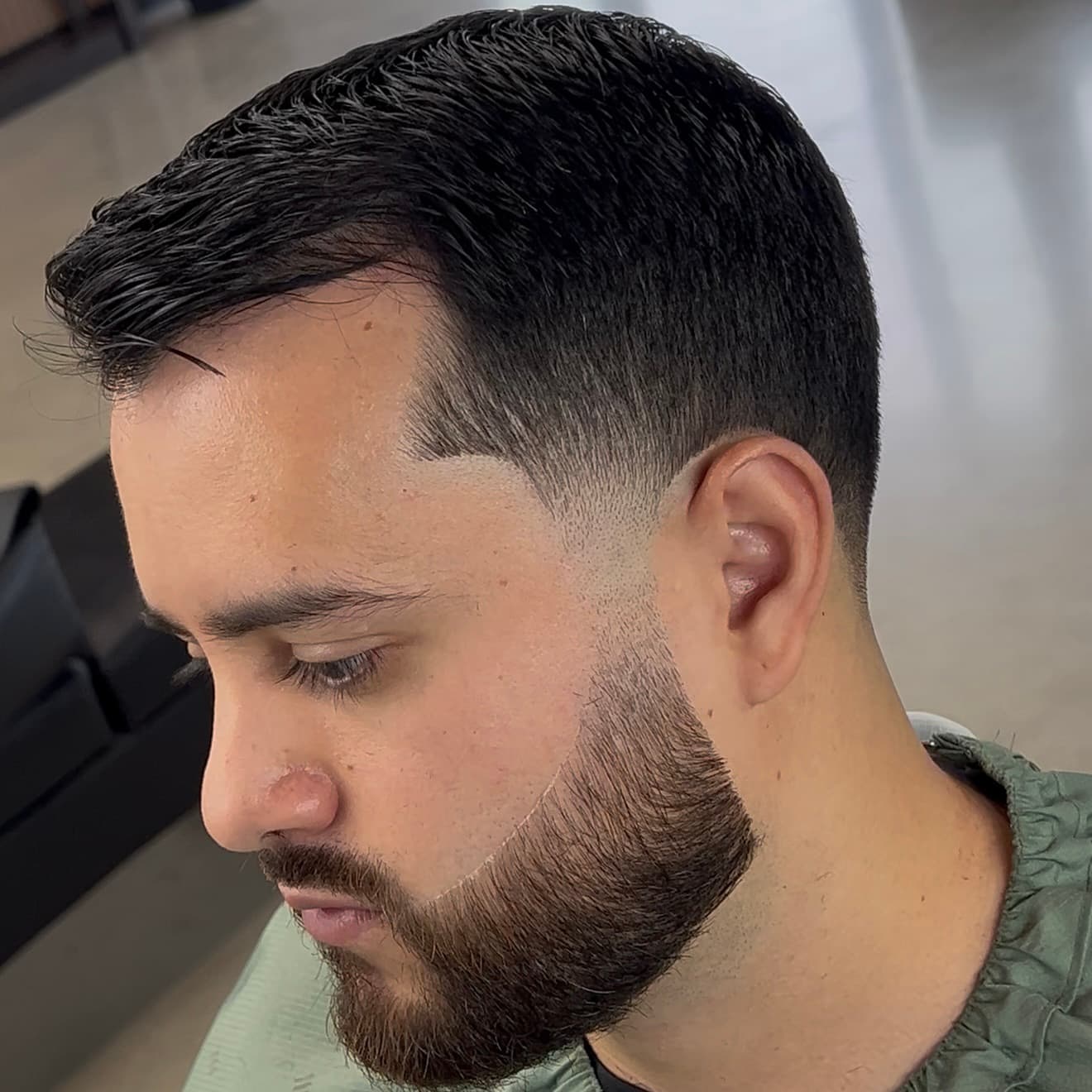 Low fade with textured top and beard lineup by Mike Drop Fades